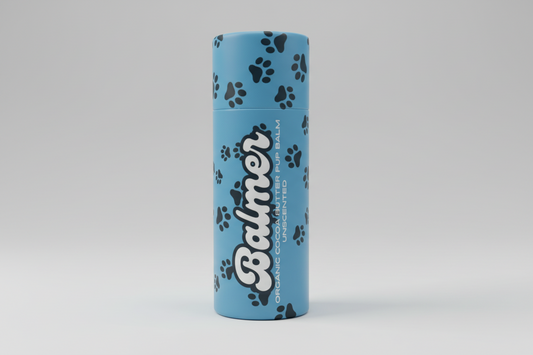 Blue cylindrical container with 'Balmer' branding on a wooden surface with a blurred outdoor background